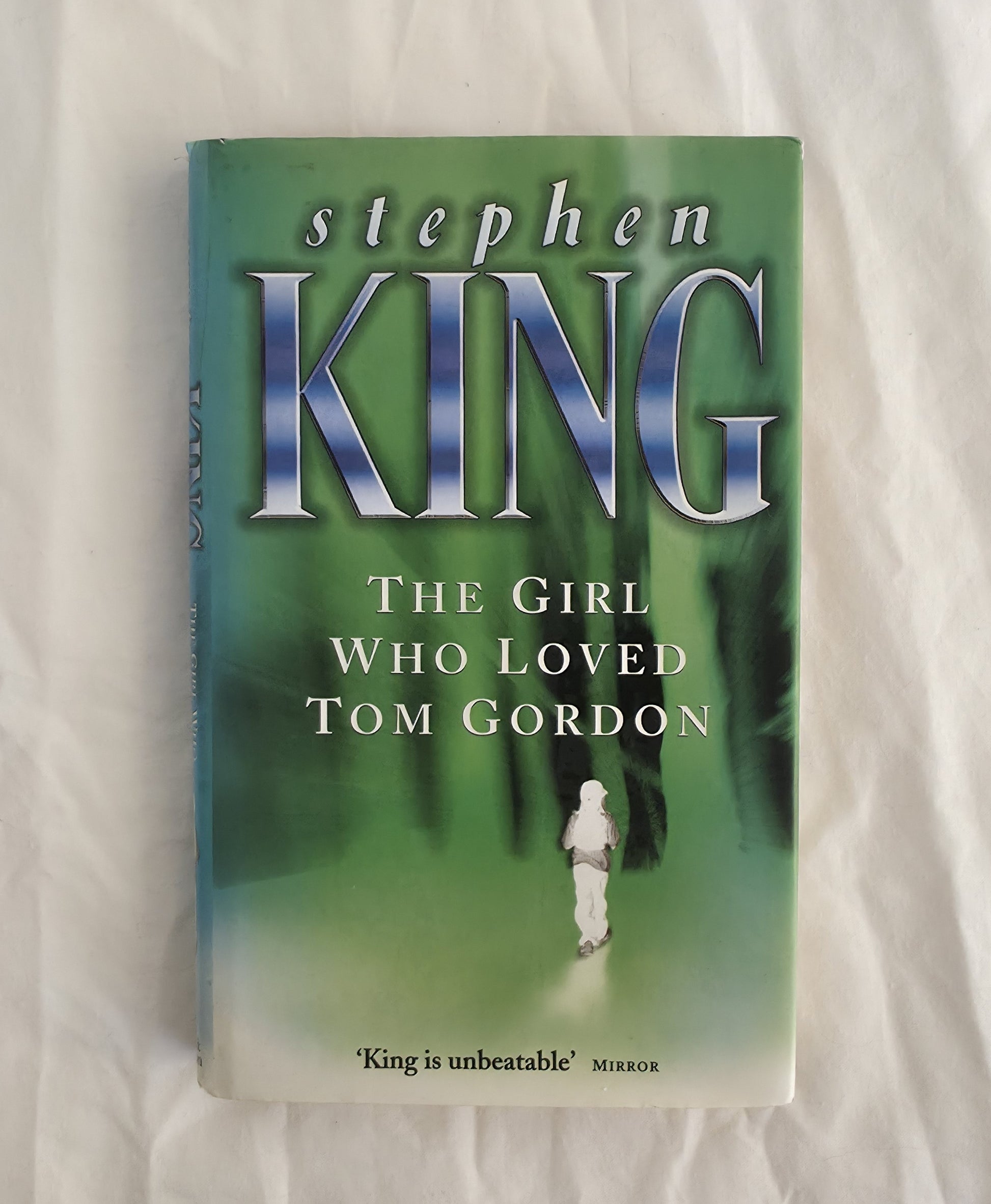 Book titled 'The Girl Who Loved Tom Gordon' by Stephen King on a light background