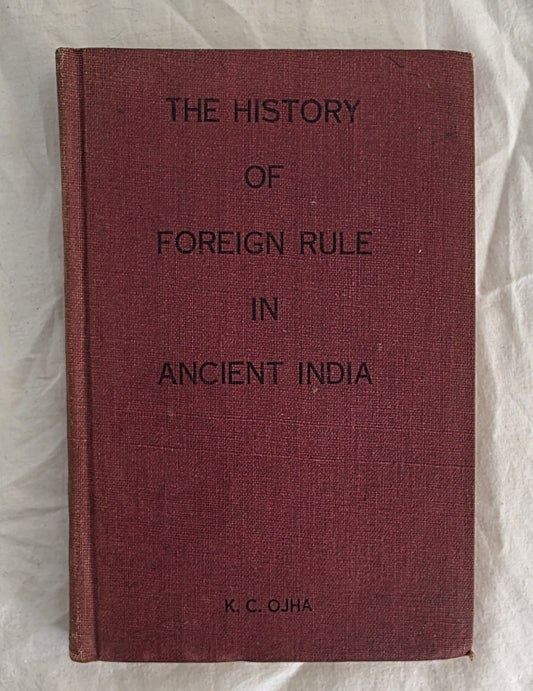 Book titled 'The History of Foreign Rule in Ancient India' by K.C. Ojha on a textured surface