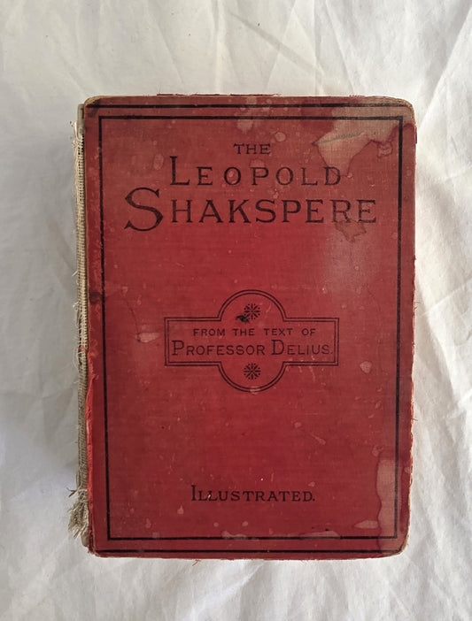 Red book titled 'The Leopold Shakspere' on a white textured background