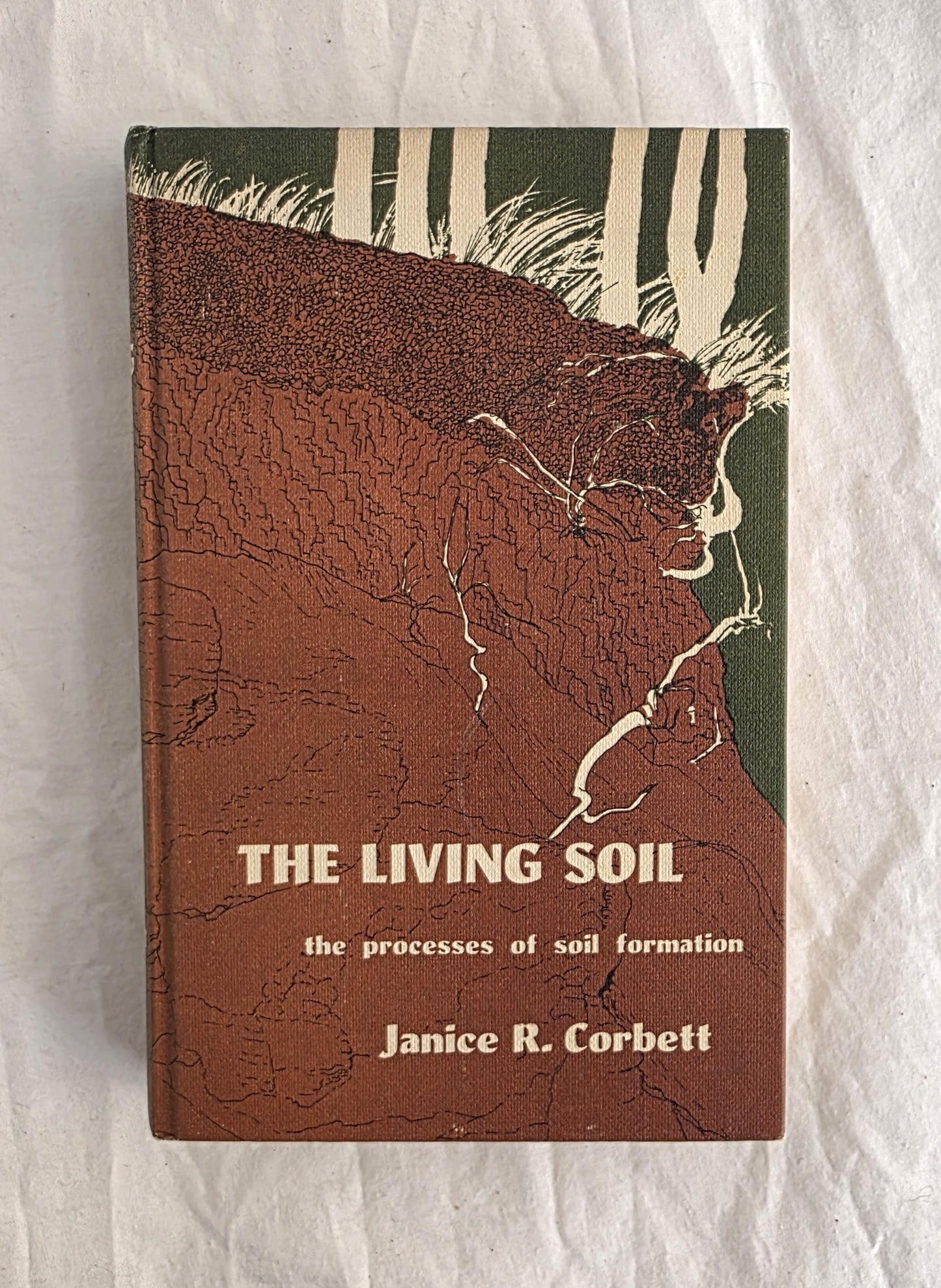 Book titled 'The Living Soil' by Janice R. Corbett on a textured white background