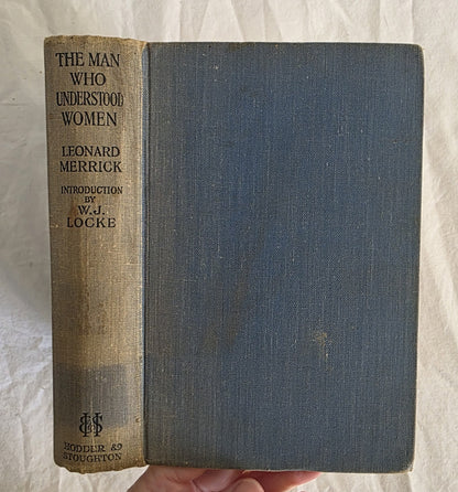 Vintage book titled 'The Man Who Understood Women' by Leonard Merrick, held against a textured white background.