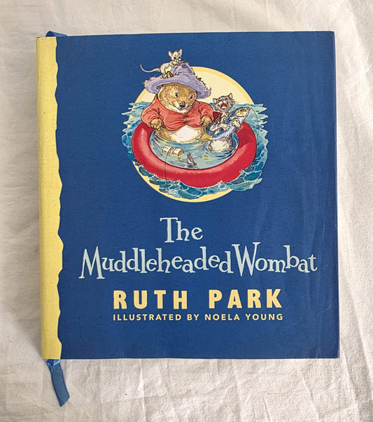 Book cover of 'The Muddleheaded Wombat' by Ruth Park with a bear illustration on a blue background.