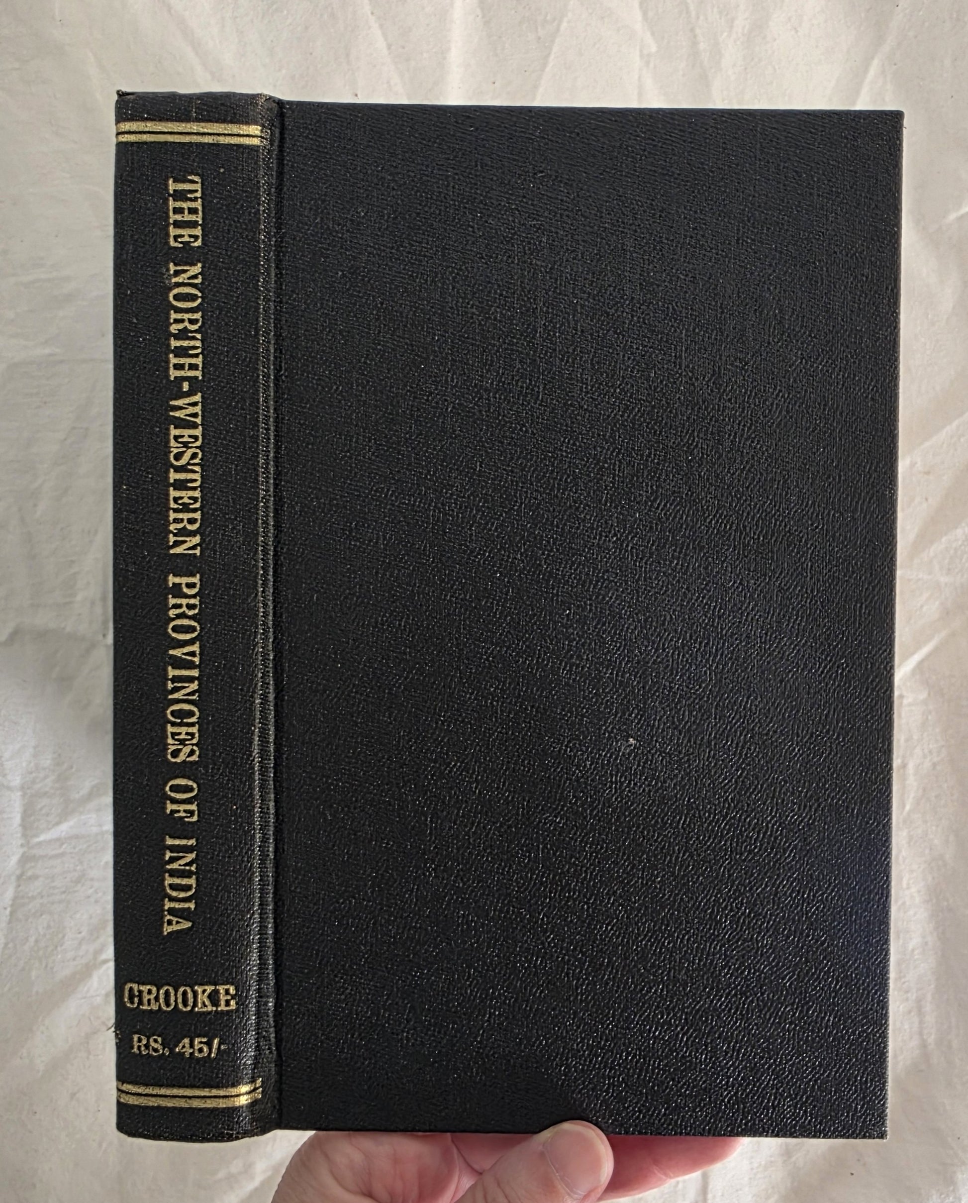 Black book with gold text on a textured white background