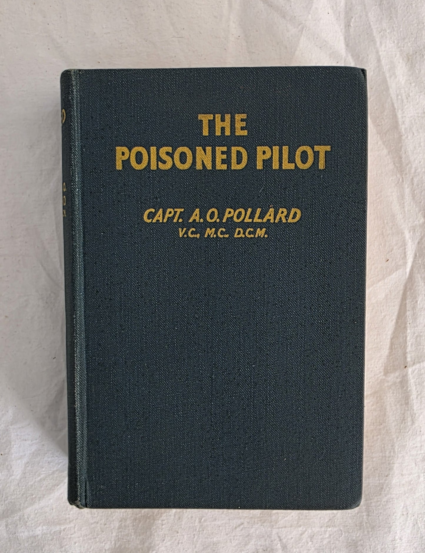 Book titled 'The Poisoned Pilot' by Capt. A.Q. Pollard on a textured white background