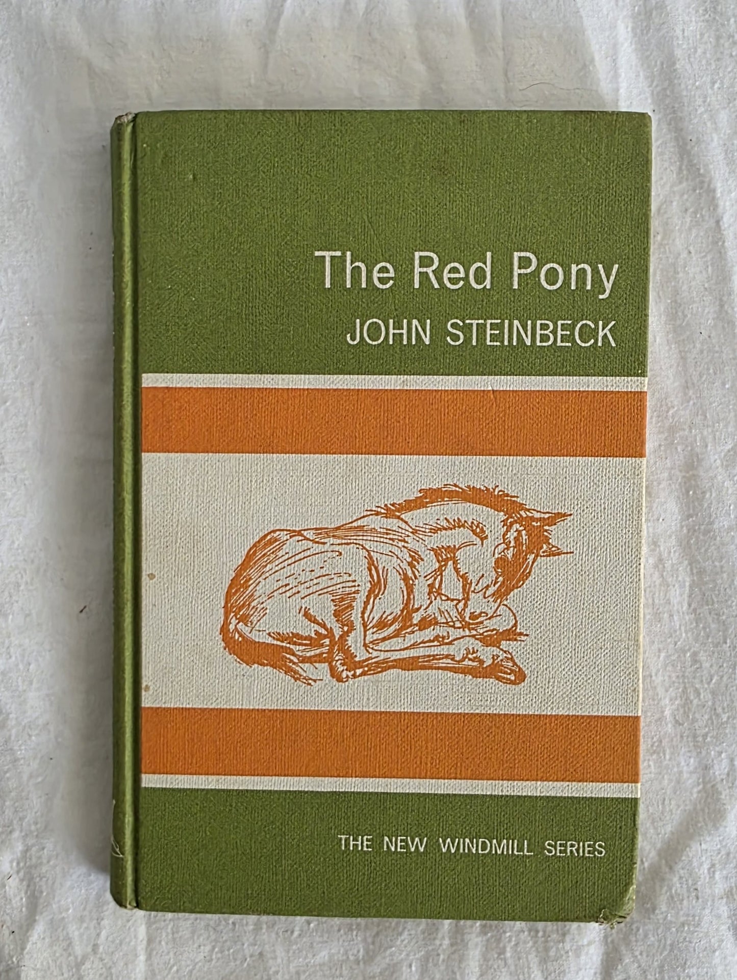 Book titled 'The Red Pony' by John Steinbeck on a white background
