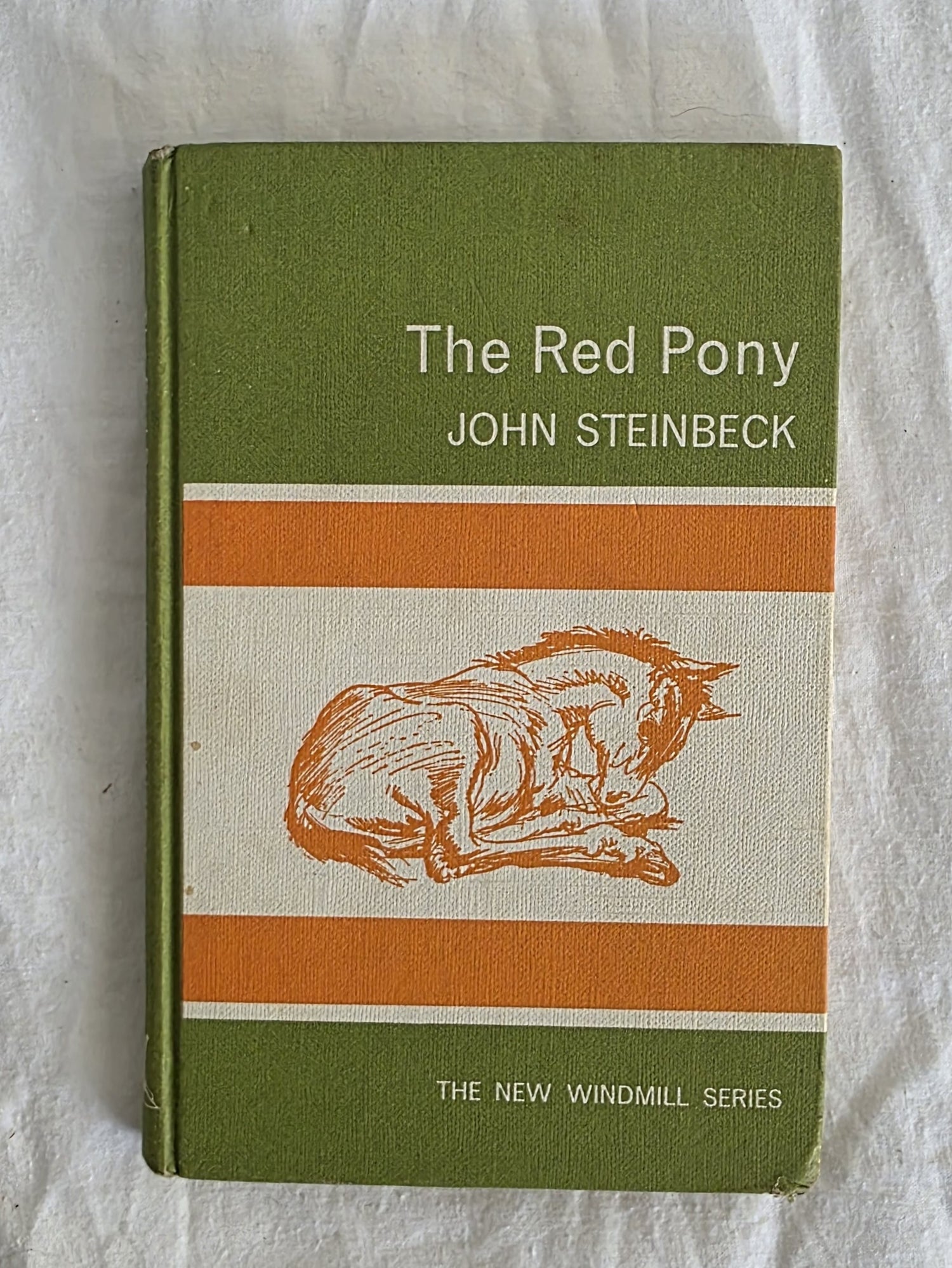 Book titled 'The Red Pony' by John Steinbeck on a white background