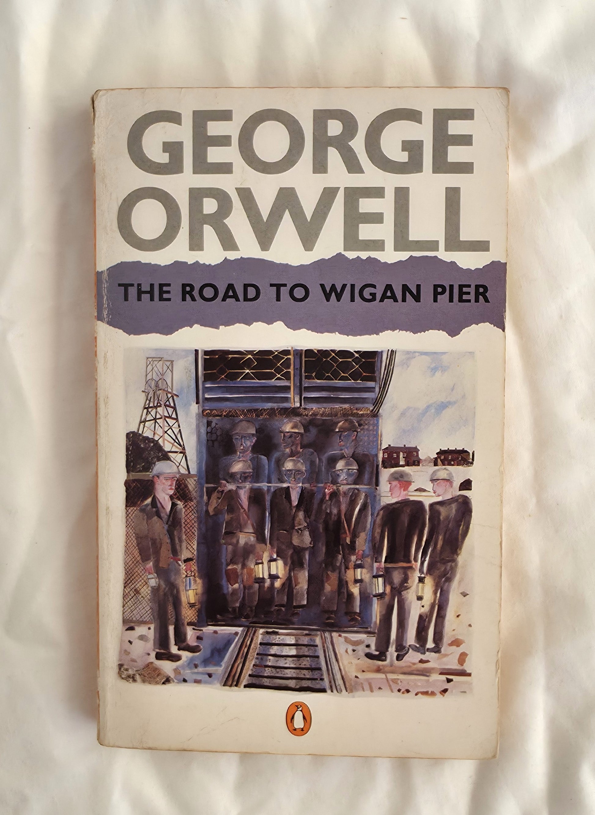 Book cover of 'The Road to Wigan Pier' by George Orwell on a textured white background