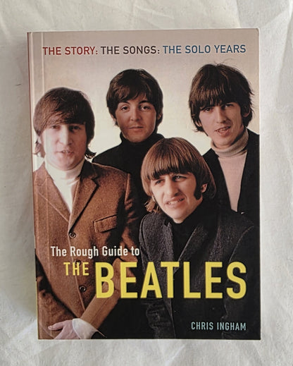 Book cover of 'The Rough Guide to The Beatles' featuring four band members on a white background