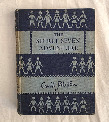 Book titled 'The Secret Seven Adventure' by Enid Blyton on a white background