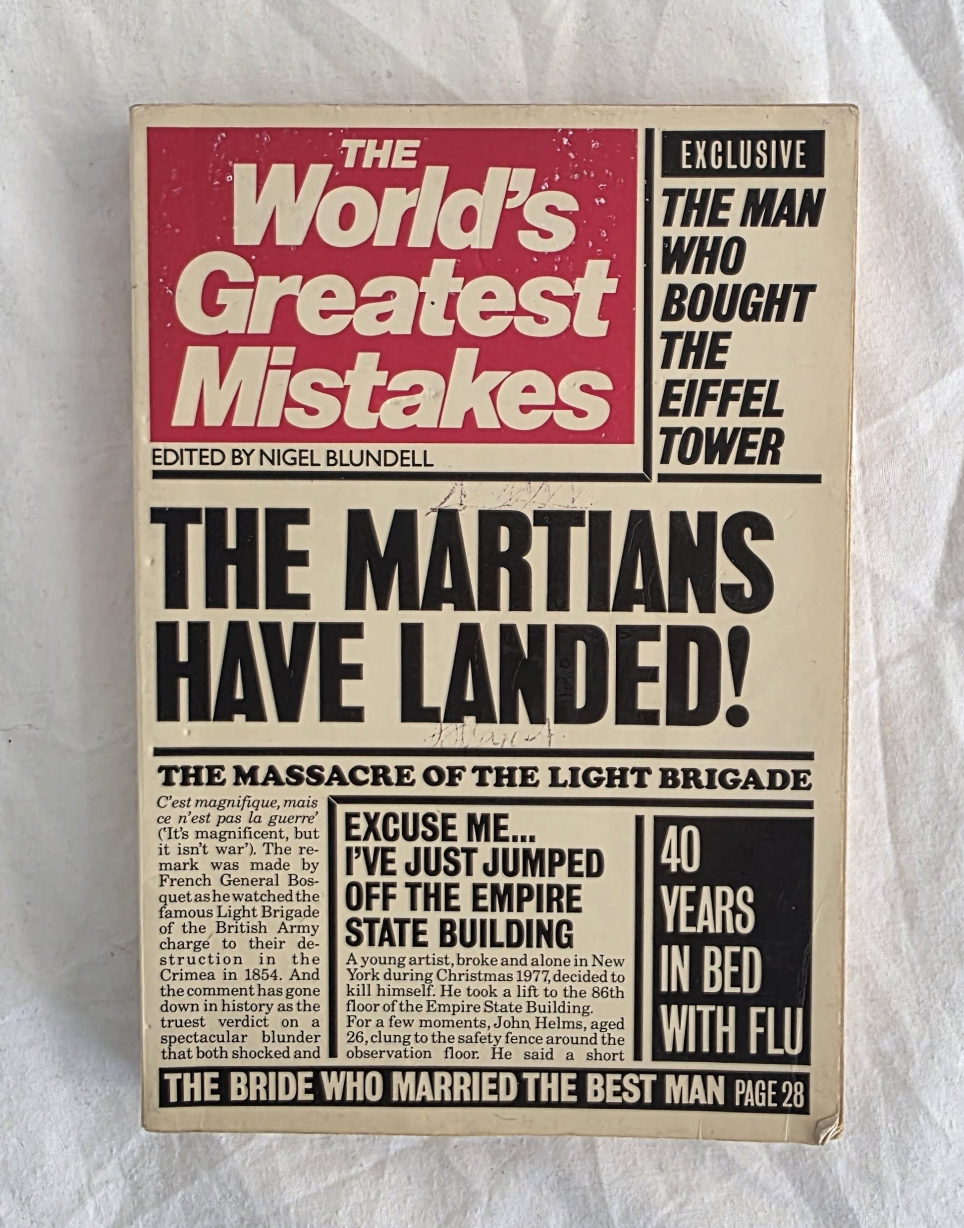 Book cover of 'The World's Greatest Mistakes' with a humorous headline about the Martians landing.