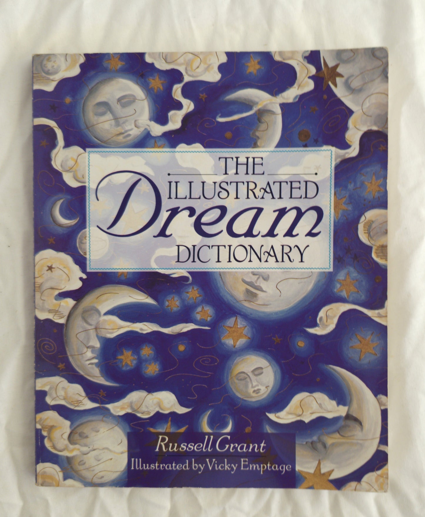 Book titled 'The Illustrated Dream Dictionary' with celestial designs on the cover.