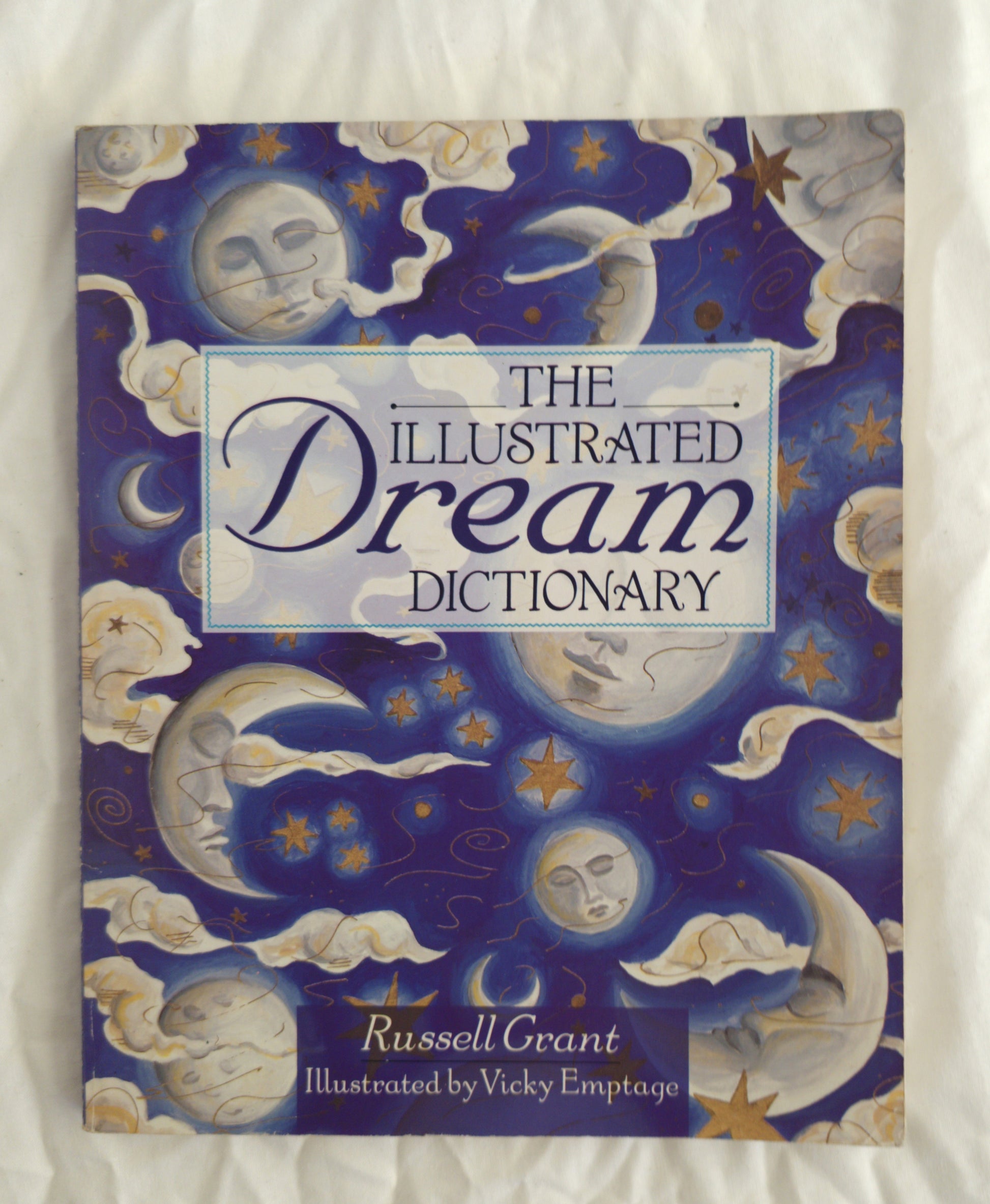 Book titled 'The Illustrated Dream Dictionary' with celestial designs on the cover.