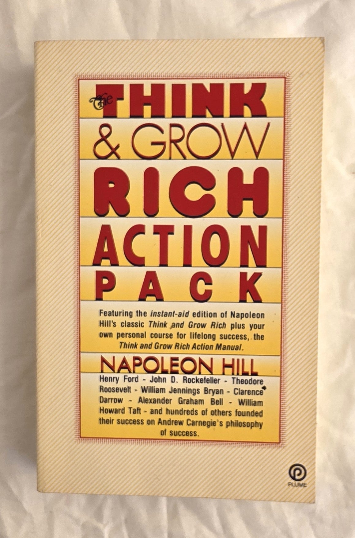 Book cover of 'Think & Grow Rich Action Pack' by Napoleon Hill on a textured beige background