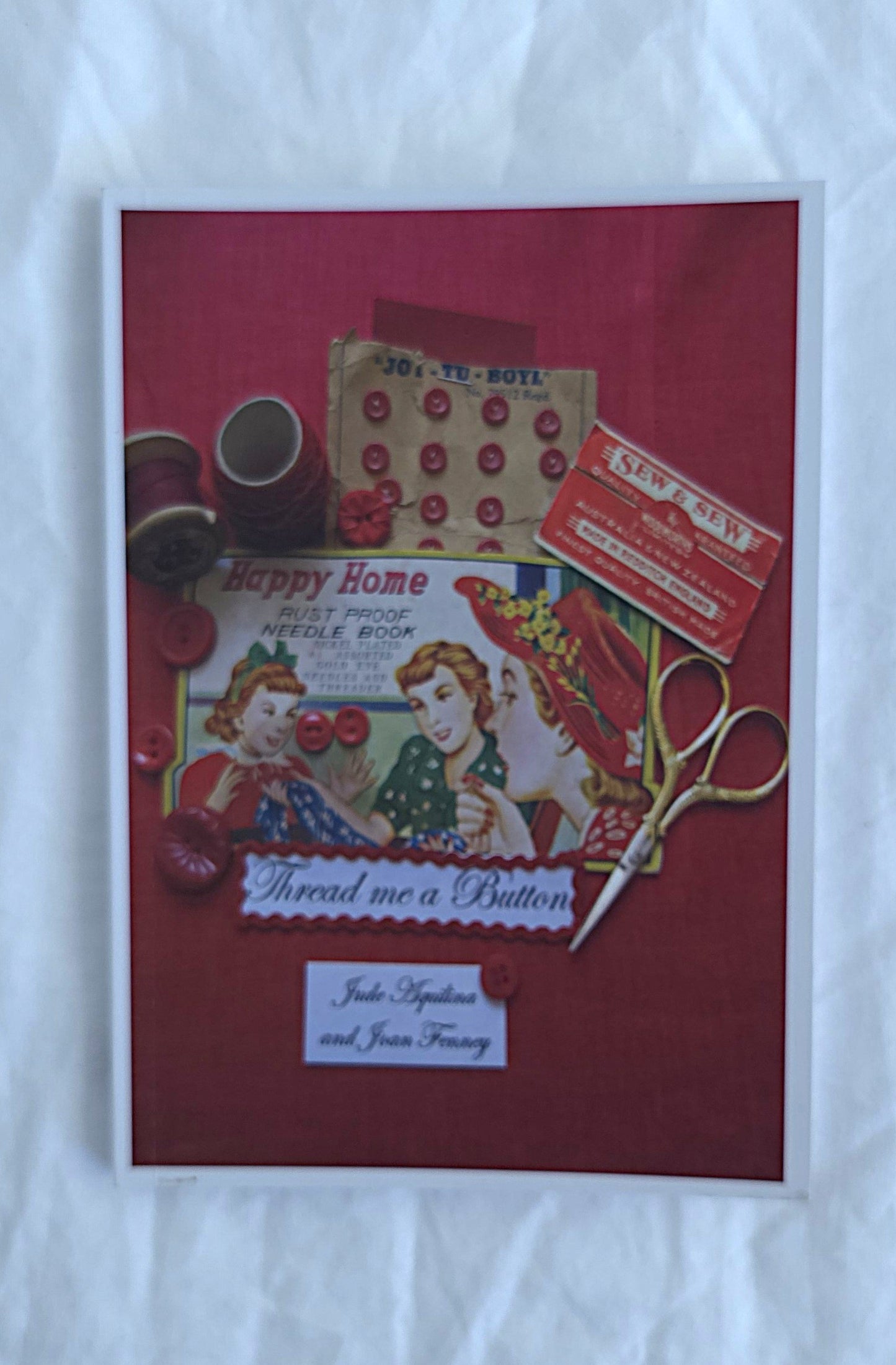 Vintage-themed booklet with sewing-related items on a red background