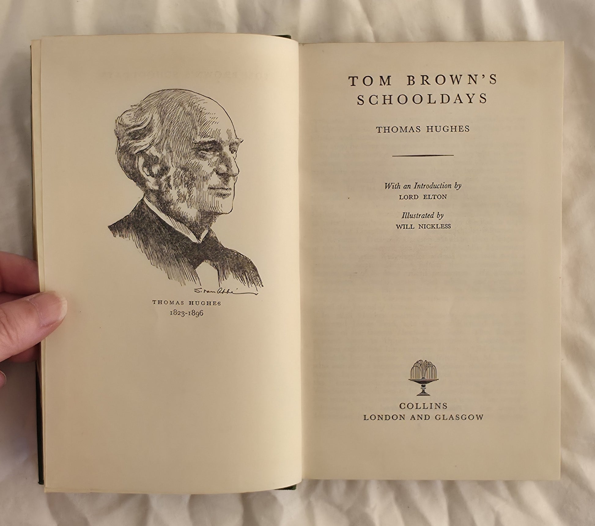 Open book titled 'Tom Brown's Schooldays' with a portrait illustration on a light background