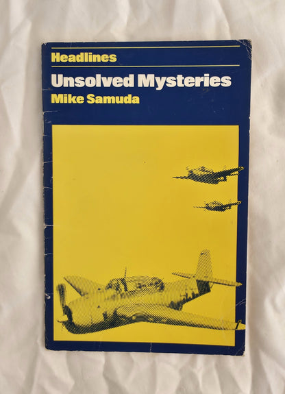 Book titled 'Unsolved Mysteries' by Mike Samuda with airplane illustration on a yellow background