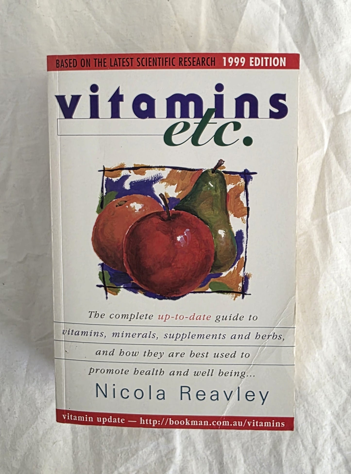 Book titled 'vitamins etc.' by Nicola Reavley on a textured white background