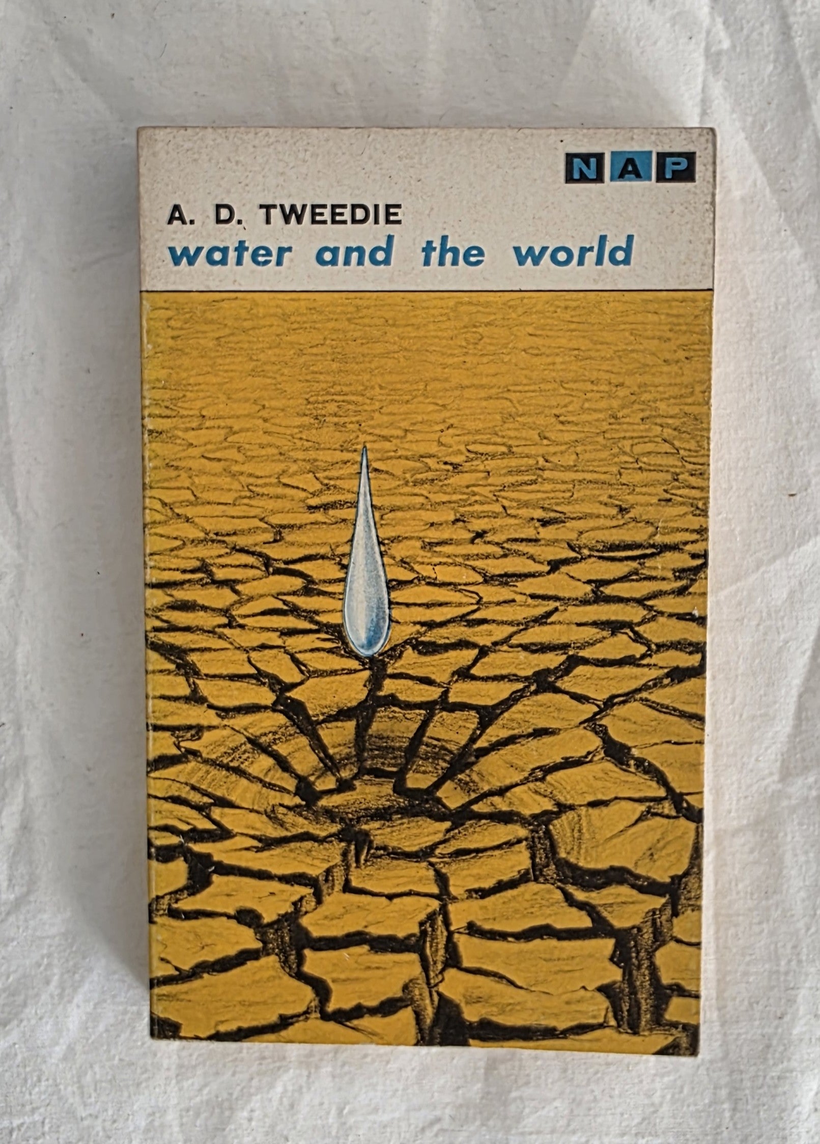 Book cover of 'Water and the World' by A. D. Tweedie with a cracked earth design and NAP logo.
