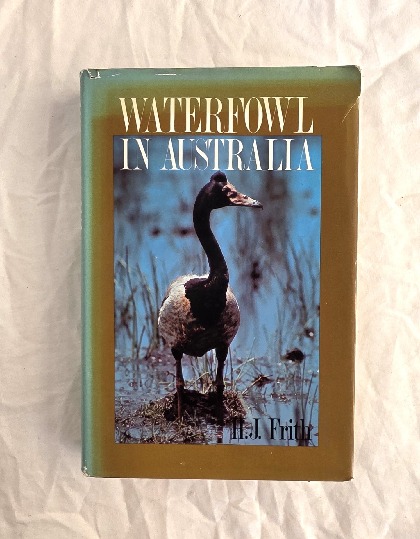 Book titled 'Waterfowl in Australia' with a duck on the cover, placed on a textured surface.