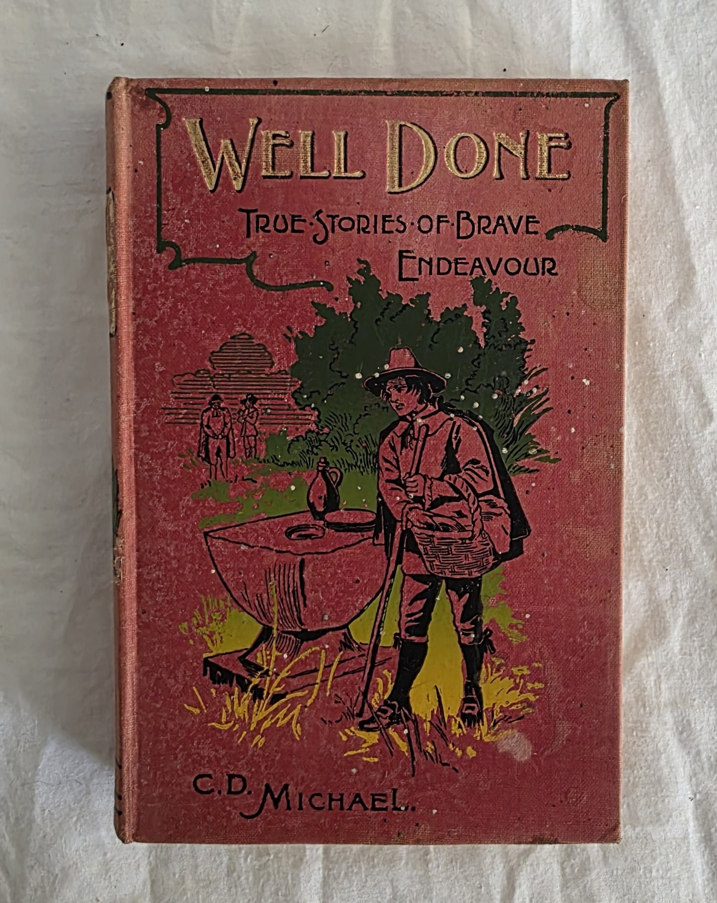 Vintage book titled 'Well Done: True Stories of Brave Endeavour' by C.D. Michael on a textured beige background.