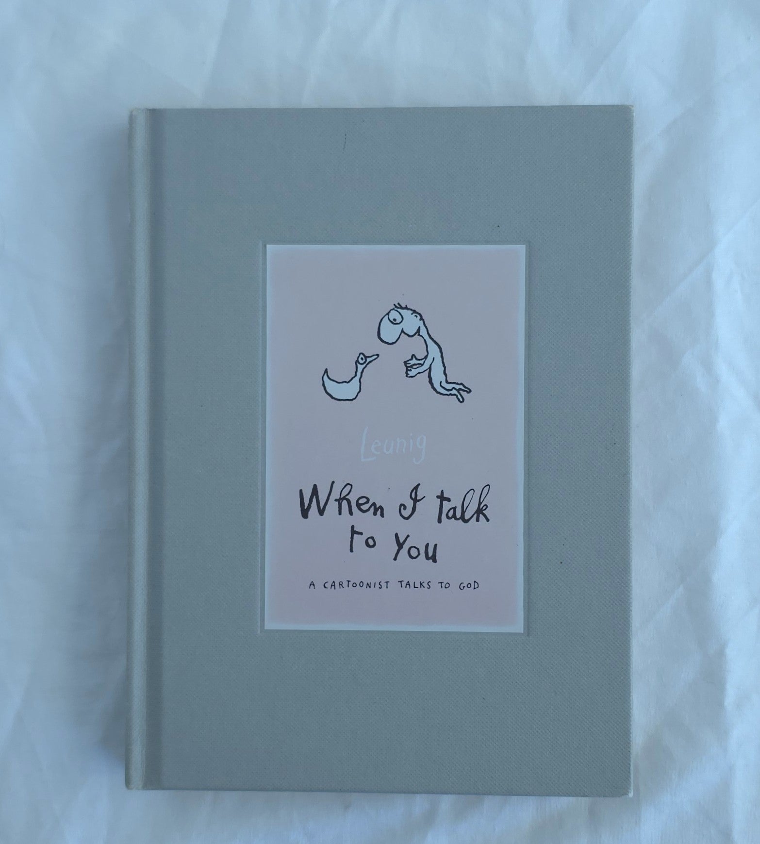 Gray book with a cover illustration and text on a white background
