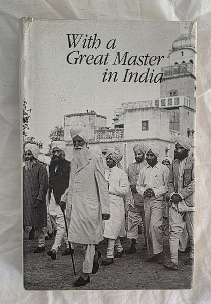 Book cover titled 'With a Great Master in India' featuring a black and white photograph of a group of men in traditional attire.
