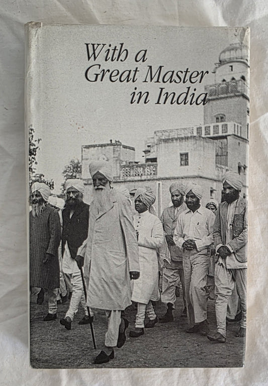 Book cover titled 'With a Great Master in India' featuring a black and white photograph of a group of men in traditional attire.